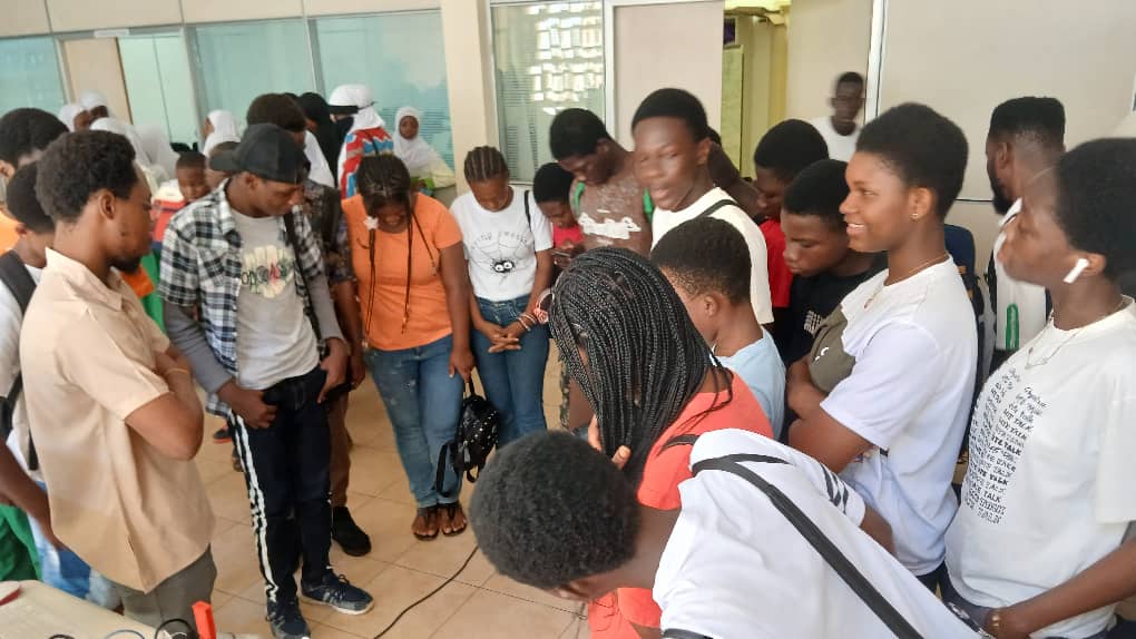 Students gathered around a hands-on STEM demonstration