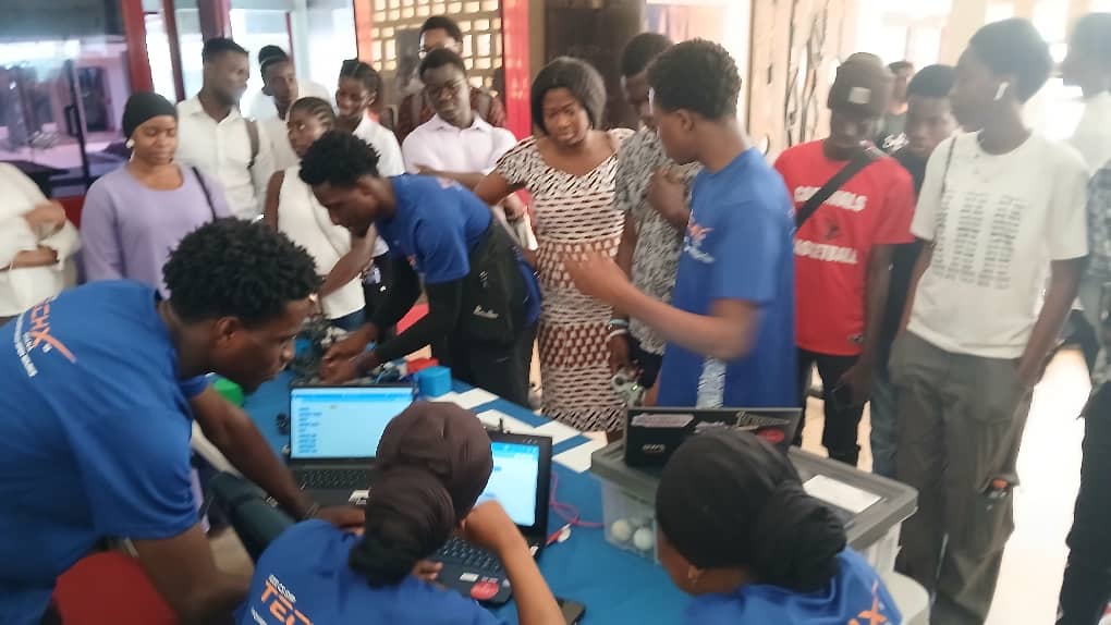 Students watching a robotics kit demonstration