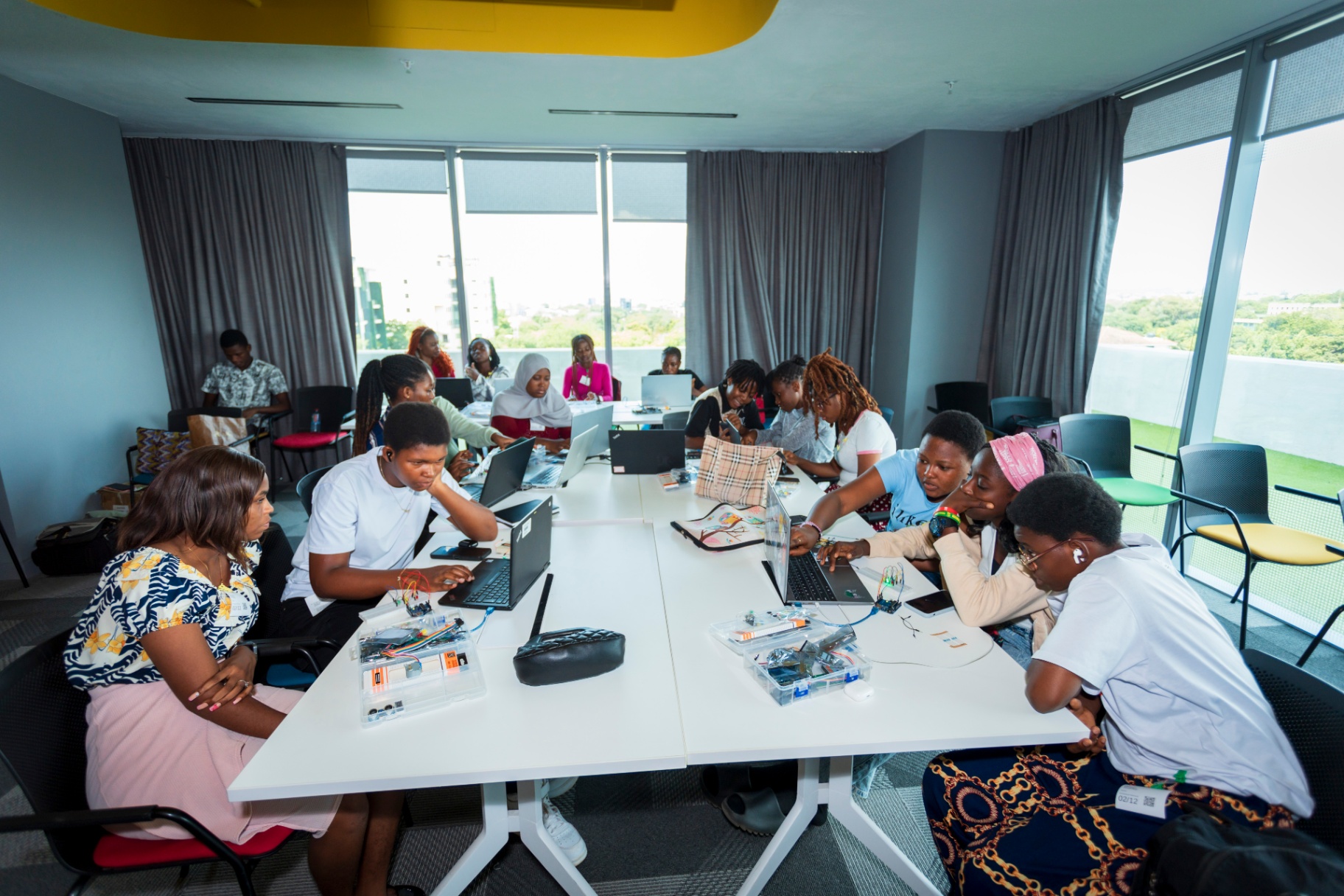 Participants collaborating across a long workshop table