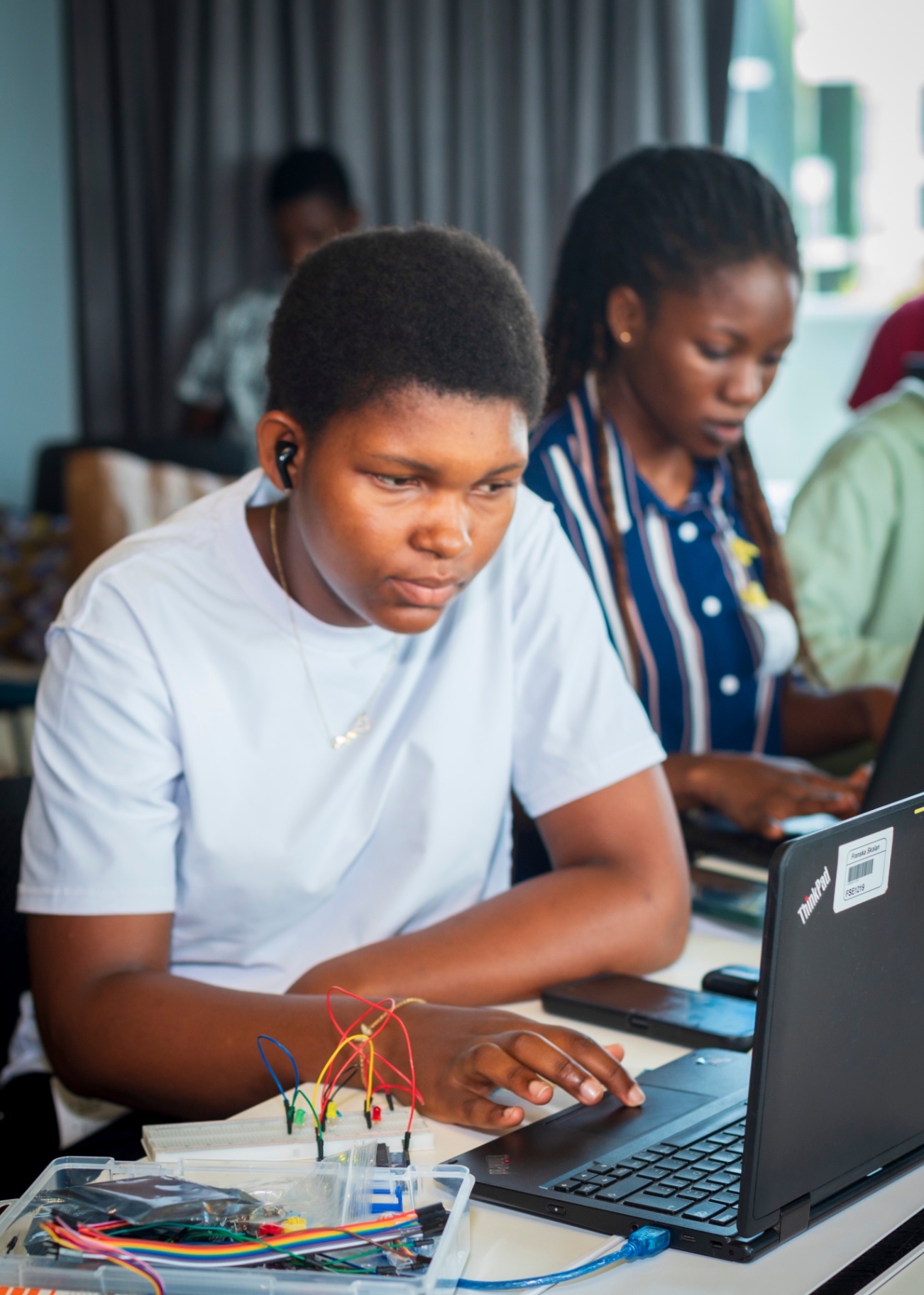 Student coding her Arduino sketch on a laptop