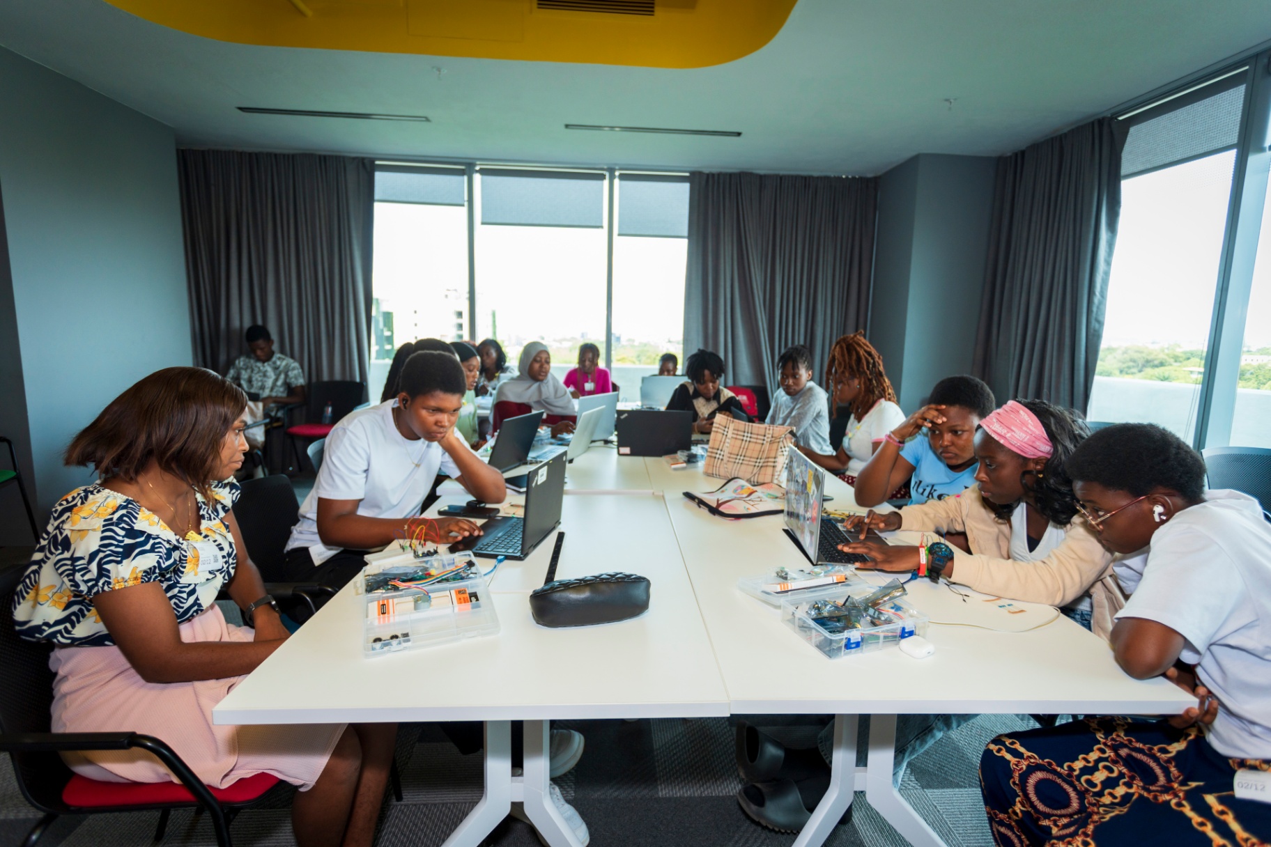 Wide view of participants working on Arduino kits in a workshop hall