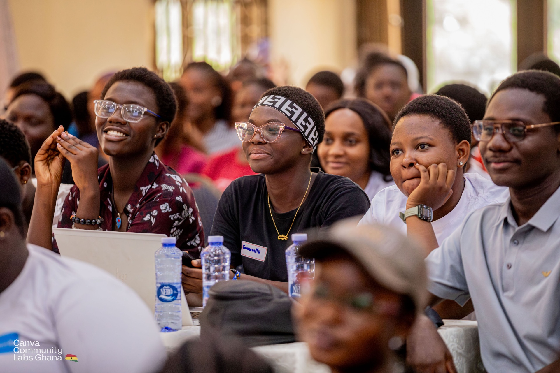 Engaged audience taking notes at a creative workshop