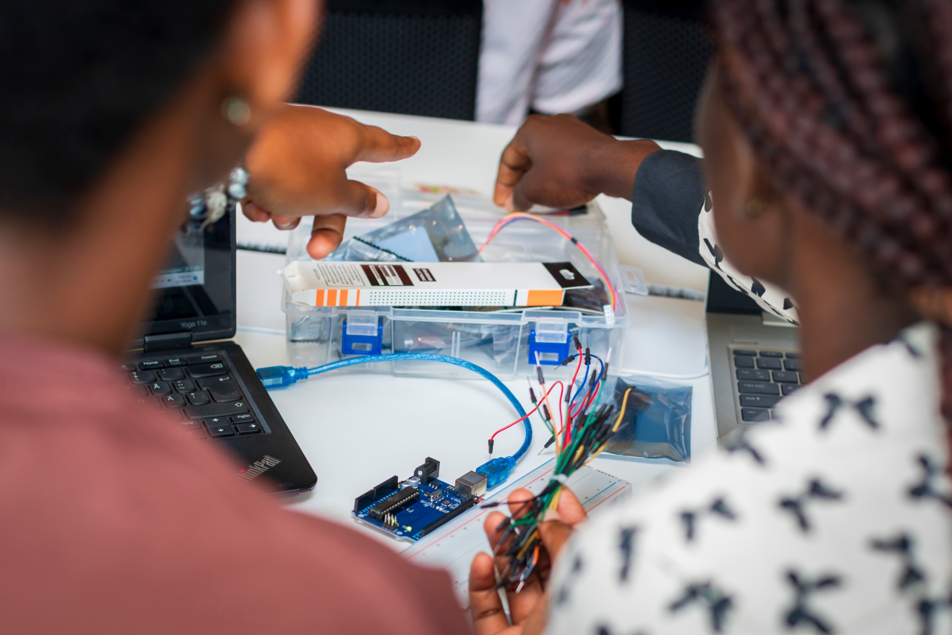 Team collaborating on an Arduino electronics kit